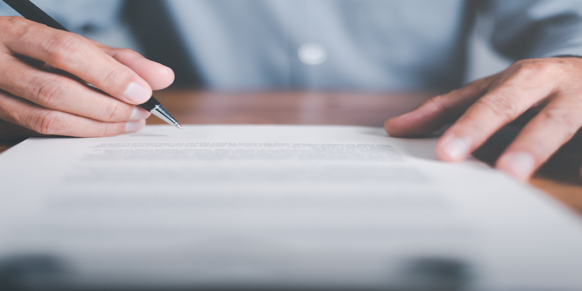 man writing on long paper