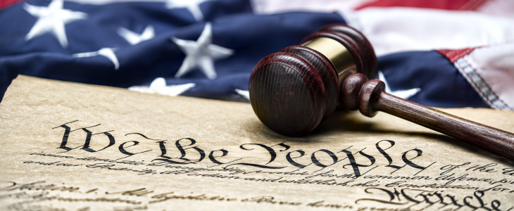 American flag with copy of the constitution and mallet